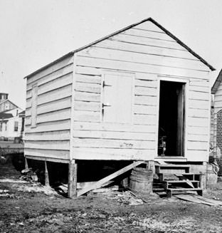 A Mitchelville house with a single door and shuttered windows.